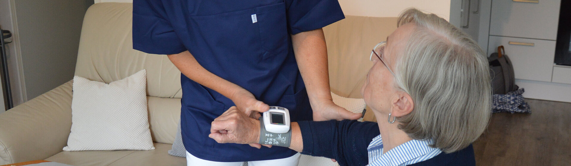 Die Mitarbeiterin des Ambulanten Pflegedienstes misst den Puls der Kundin Die Mitarbeiterin des Ambulanten Pflegedienstes misst den Puls der Kundin