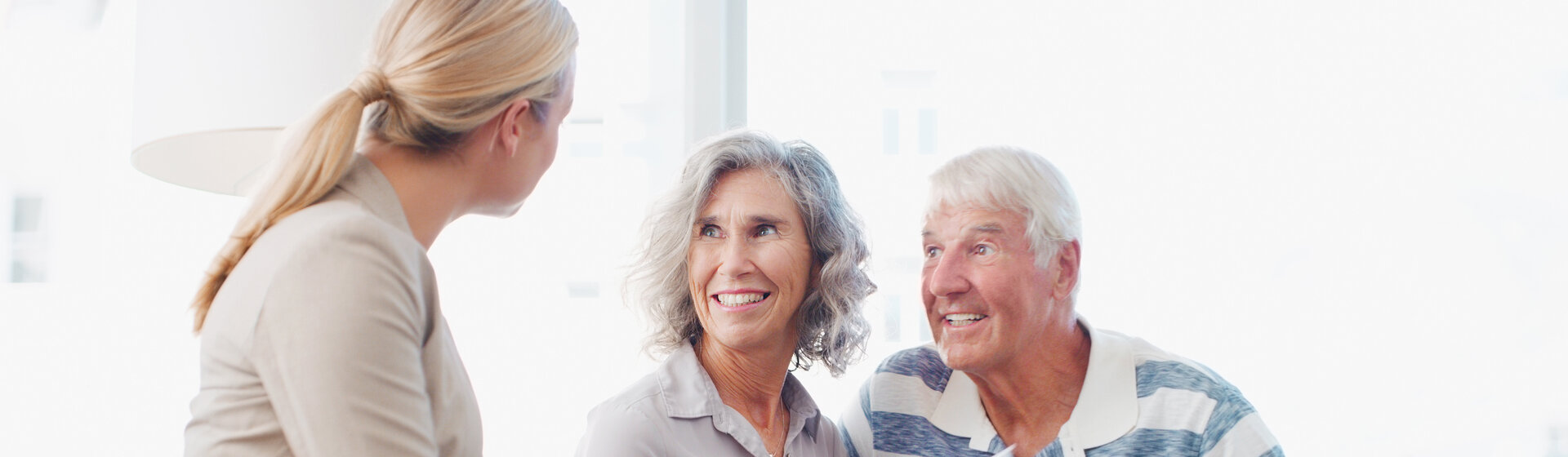 Ein älteres Paar wird von einer Mitarbeiterin beraten. Ein älteres Paar wird von einer Mitarbeiterin beraten.